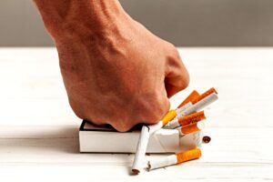 Punching a pack of cigarettes to QUIT SMOKING