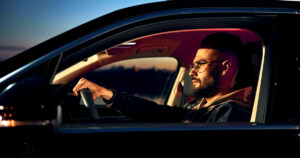 Man looking tired and sleepy while driving