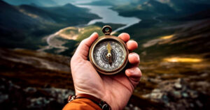 Man using a compass on a road trip